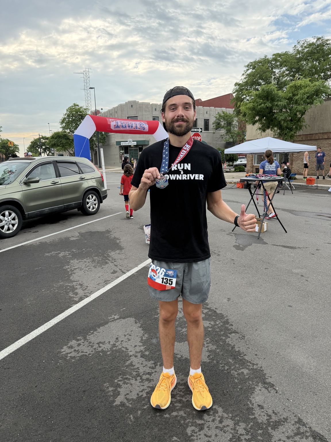 Greg holding a medal after a Downriver run